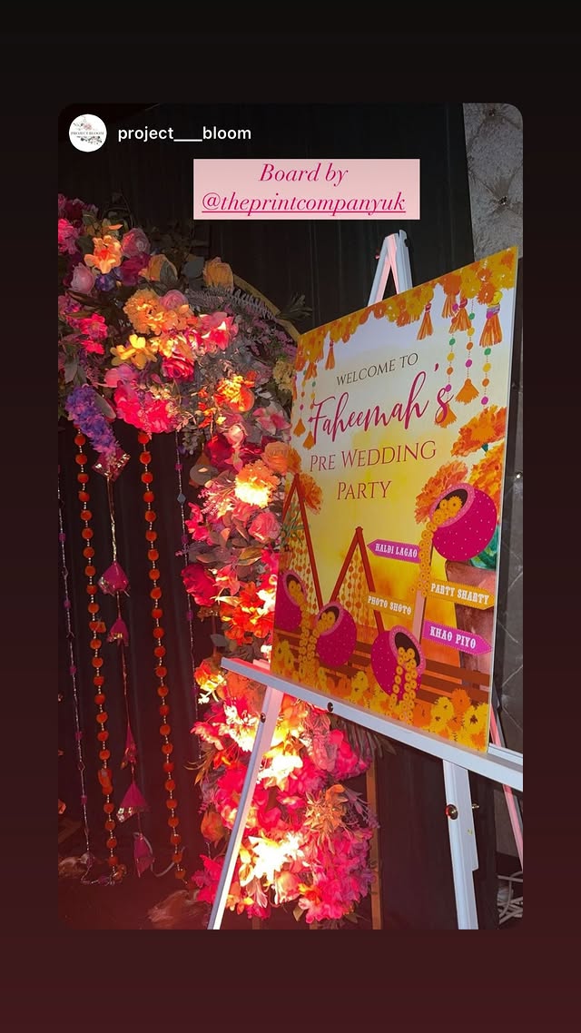 A bright pre-wedding party board displayed beside floral event decor
